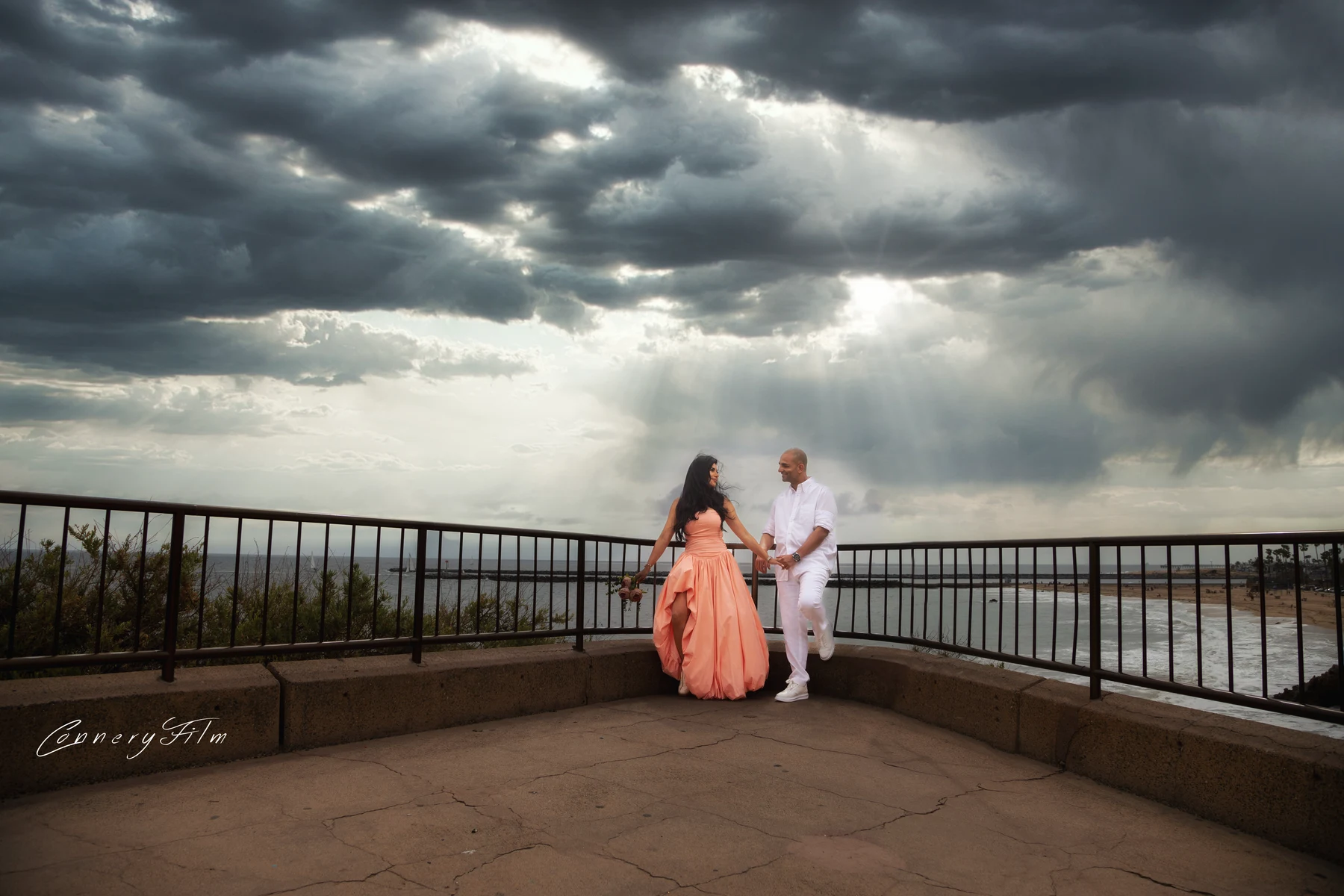 Two Los Angeles wedding photographers capturing the ceremony from different angles at a Malibu estate during golden hour